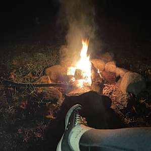 Cozying up to the fire under the stars