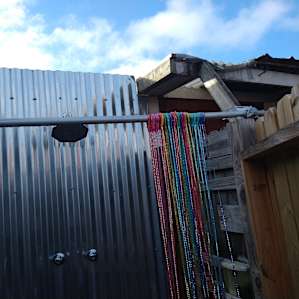 Outdoor shower with rainforest shower head, hot water.