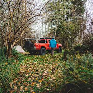A path cutting to the back of the camping area.
