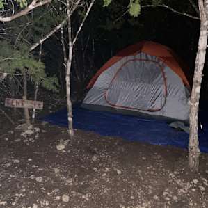 The tent spot is to the left and there’s a sign - it’s easy to miss, so make sure to look for it.