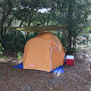 Daytime view of tent site, Kale. Extension cord from tent to electrical box.