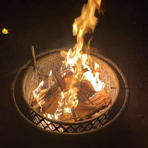 Campfire ring provided has swivel grate for cooking and cover to ensure no escaping coals at night