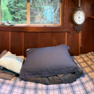 Panorama of the sleeping area. Just spacious enough for two people plus their luggage.