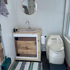 The outdoor bathroom is practically touching the back wall of the cabin (very short walk around the cabin) and is very clean.