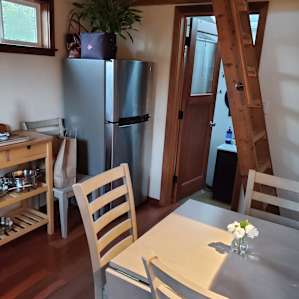 Kitchen, door to bath and ladder to loft