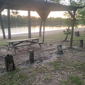 Covered picnic table by the river, adjacent to our site