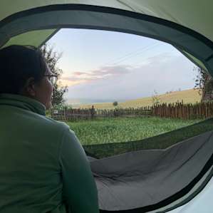 Inside our tent with a view of the sunset over the rolling hills