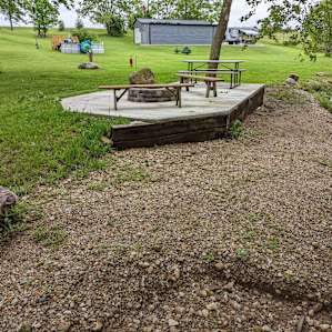 A spacious deck with a custom fire pit next to the bubbling Creek!