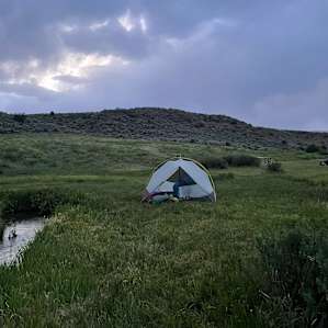 Serene evenings at camp, with the sound of the stream outside the tent.