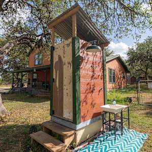 This FLUSHING toilet is near the host home, an outdoor SHOWER!! YEA!