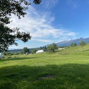 On the left is the glamping tent for rent. The stargazer pad is just to the left of the large white event tent. The outhouse is between the pad and the event tent.