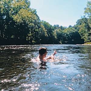 Up river in the Pigeon river pointing at glamping spot in the distance.