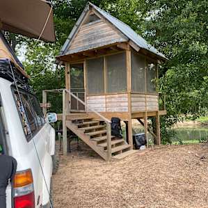 Screened-in and will easily sleep 4 if you had sleeping bags and pads underneath.