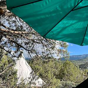 view from picnic table (umbrella already set up!), teepee’s right there to the left