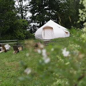 The Sunrise Bell tent—tucked away toward the back of the meadow.