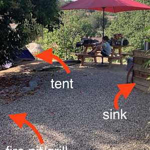 Firepit is up a little walk way or up some stair rocks from the back of the tent- it circles around. RV bathroom is down a walkway near the host house and where you park.