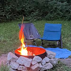 Fire ring, wood, and a grate for use if wanted. Picnic table close by as well as covered trash can.
