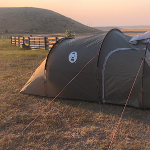 Tent set up in the pasture at sunset