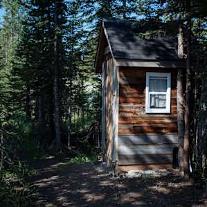 Cute little log outhouse is steps from the tent