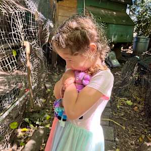 Snuggles with llama while visiting the chickens