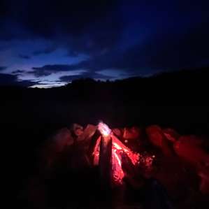 Blue sky over campfire