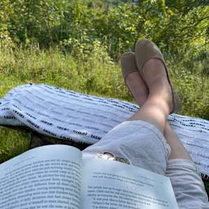 Propping my feet up in the shade while reading