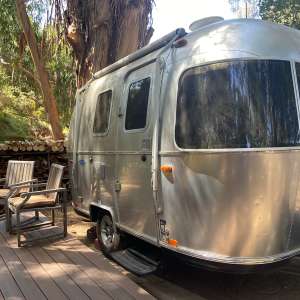 Tiny Airstream Surrounded by Trees
