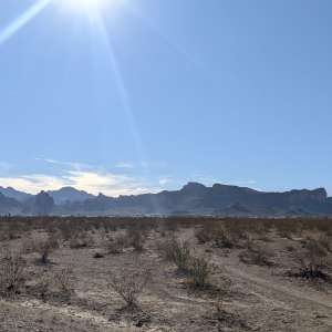 Flat desert with mountain views.