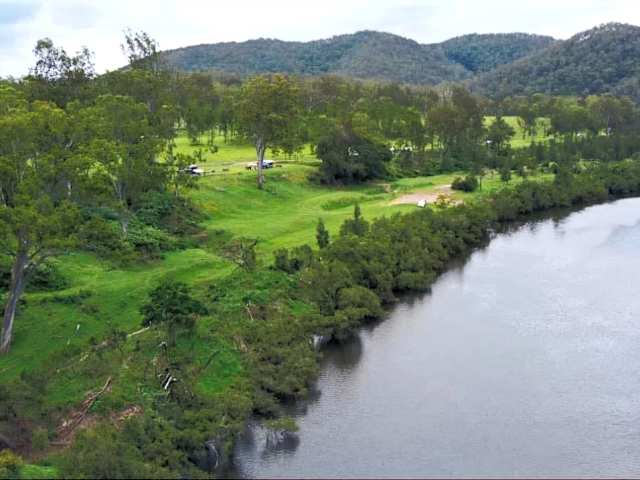Aerial view of the Clarence River winding through forested hills and green pasture