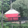 Red yurt in beautiful setting