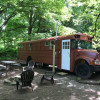 The Happy Camper Bus by the River