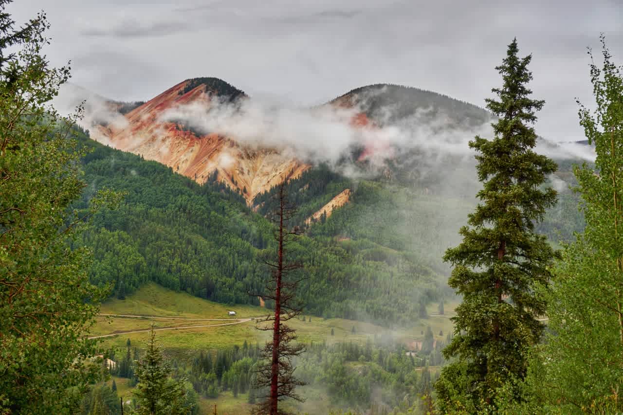 Big Red Mountain and Little Red Mountain as seen from Stunner Pass. The brilliant red and yellow hues come from the high mineral content found in the mountains.
