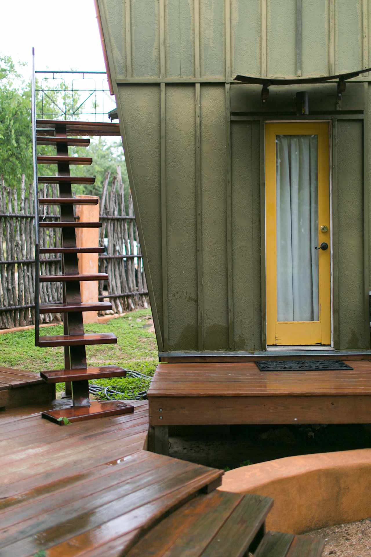 The detached bathroom and the staircase that leads up to the wine deck.