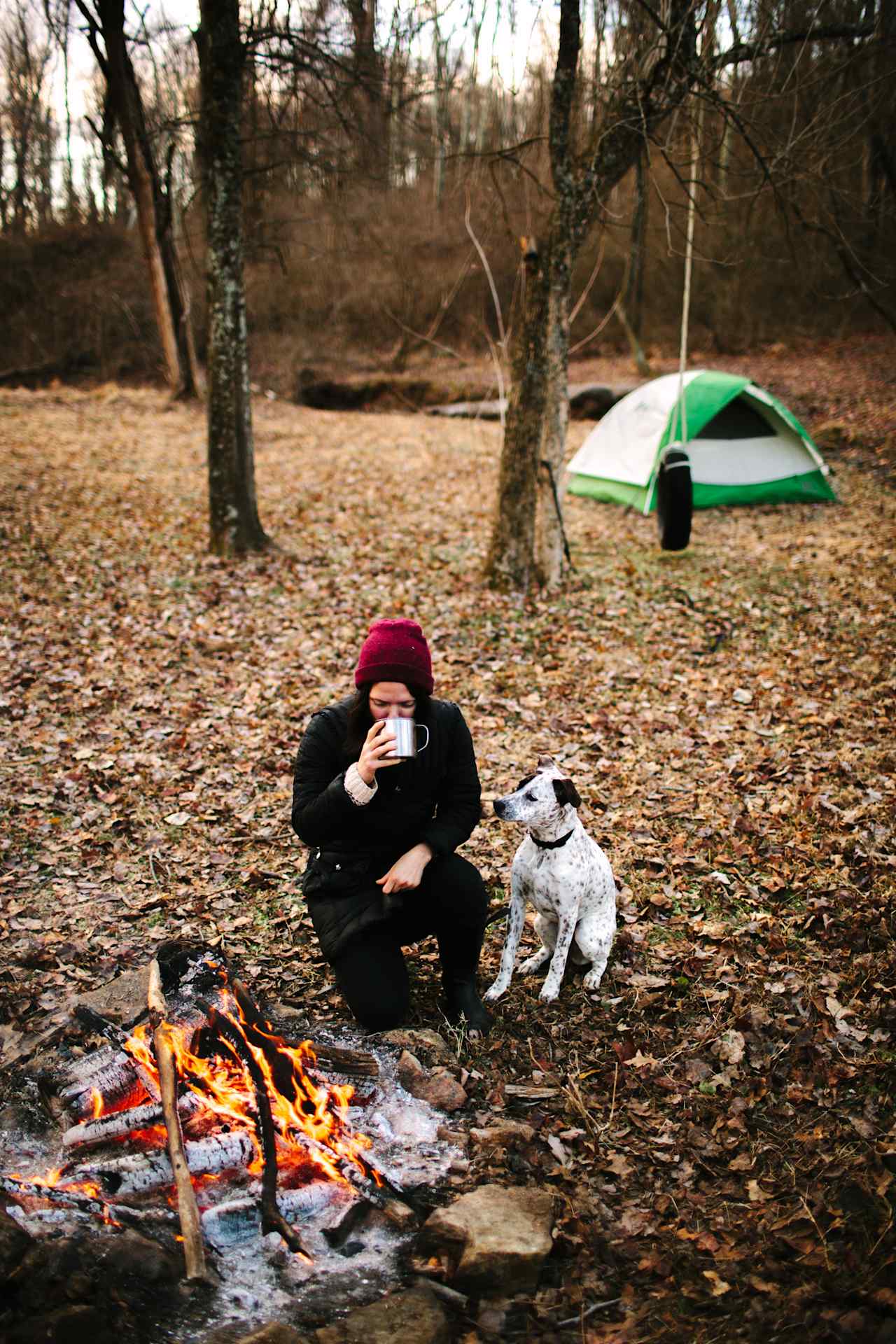 Enjoying a warm cup of coffee at the campsite by the fire on a cold, winter morning. 