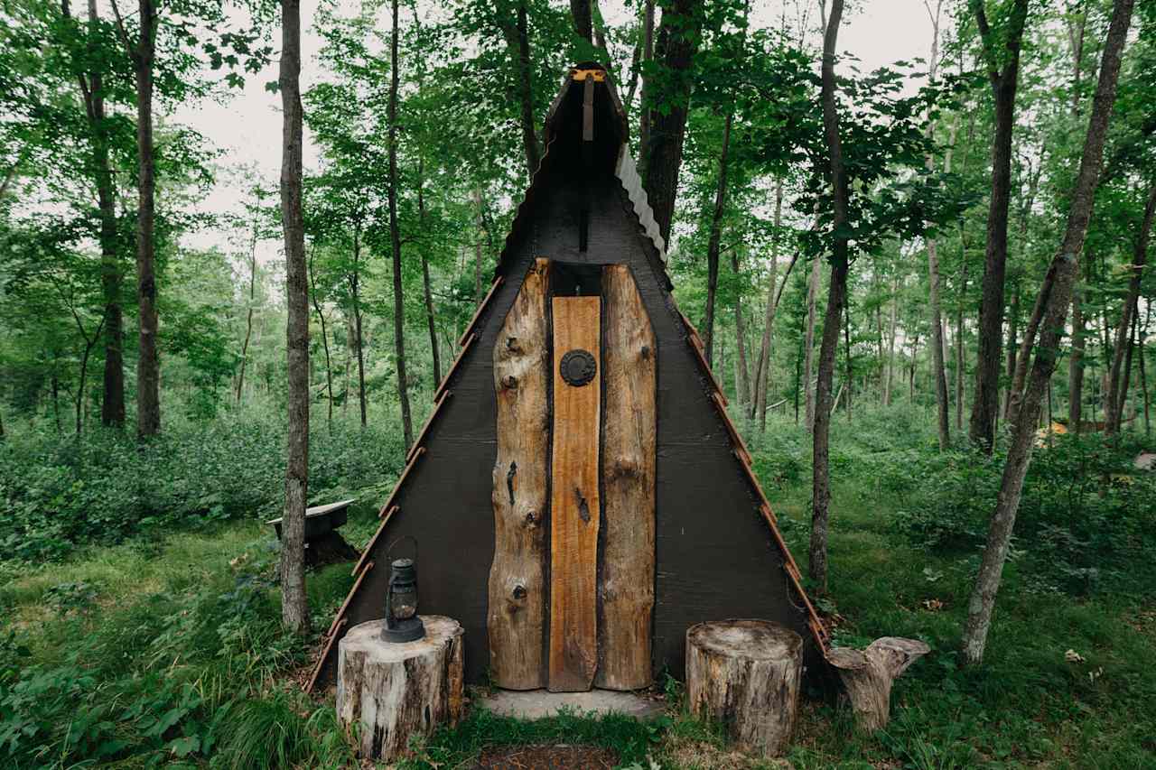The exterior of the pit toilet.