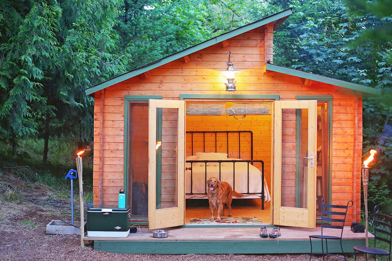 Tiki torches light the outside and fairy lights light the inside of the cabin.