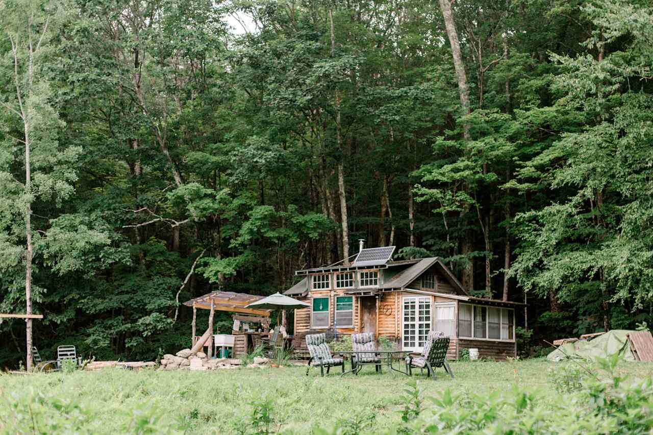 View of the cabin while walking up the wooded path from the parking area