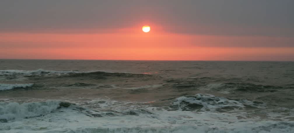 Sunset on the beach, one mile away.