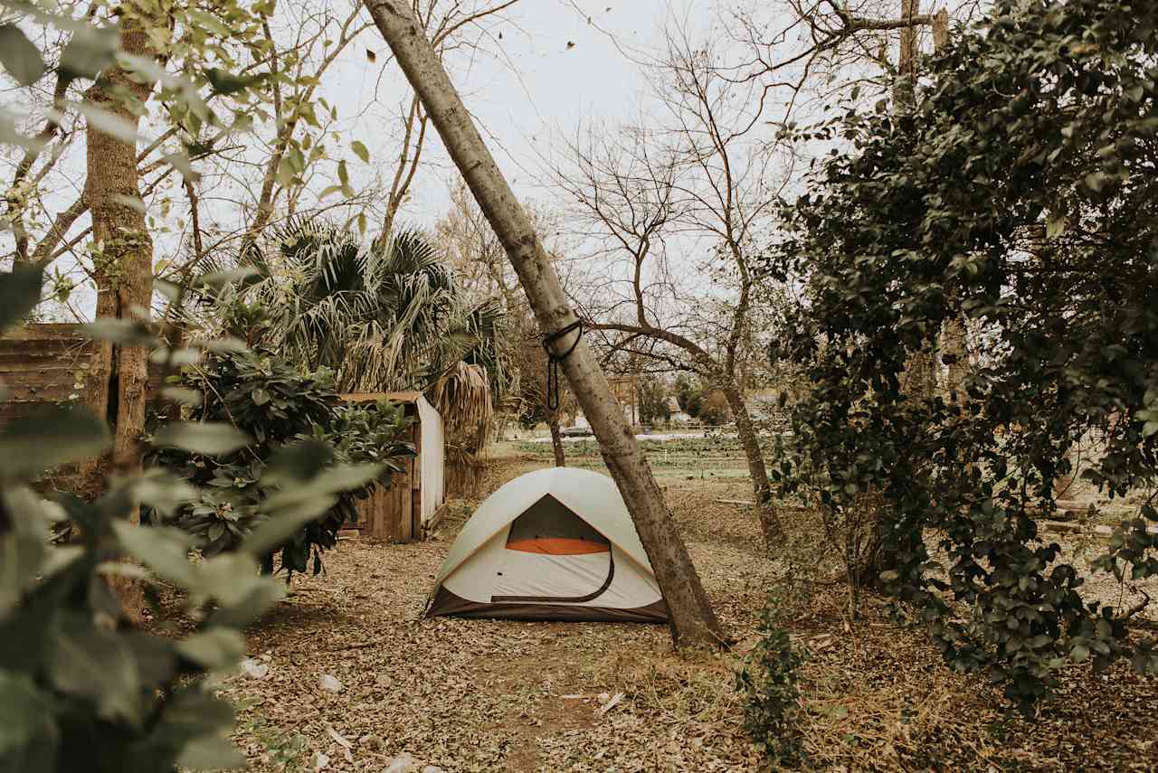 The campsite is tucked by the fence next to the farmhouse. There's enough space for one large tent or two small tents.