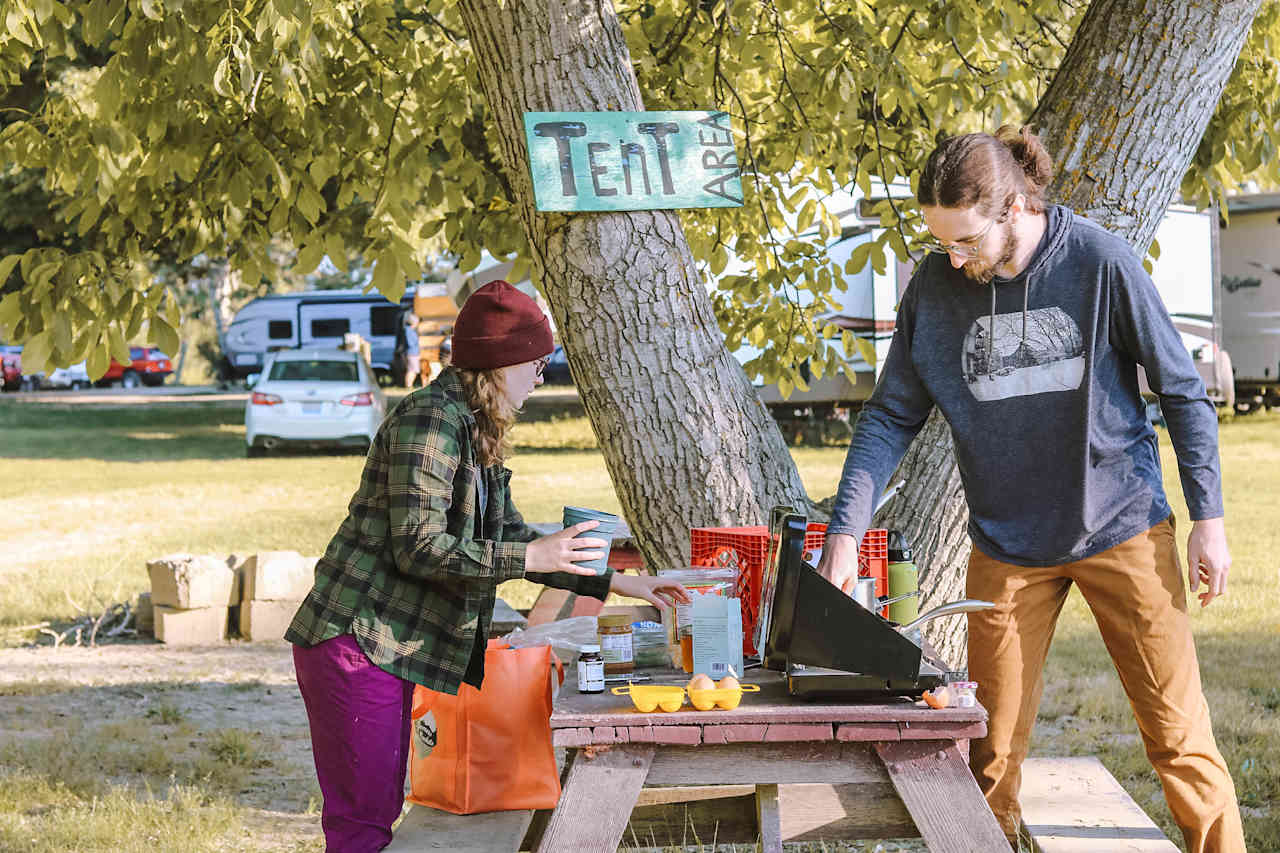 Making breakfast on one of the picnic tables in the tent area