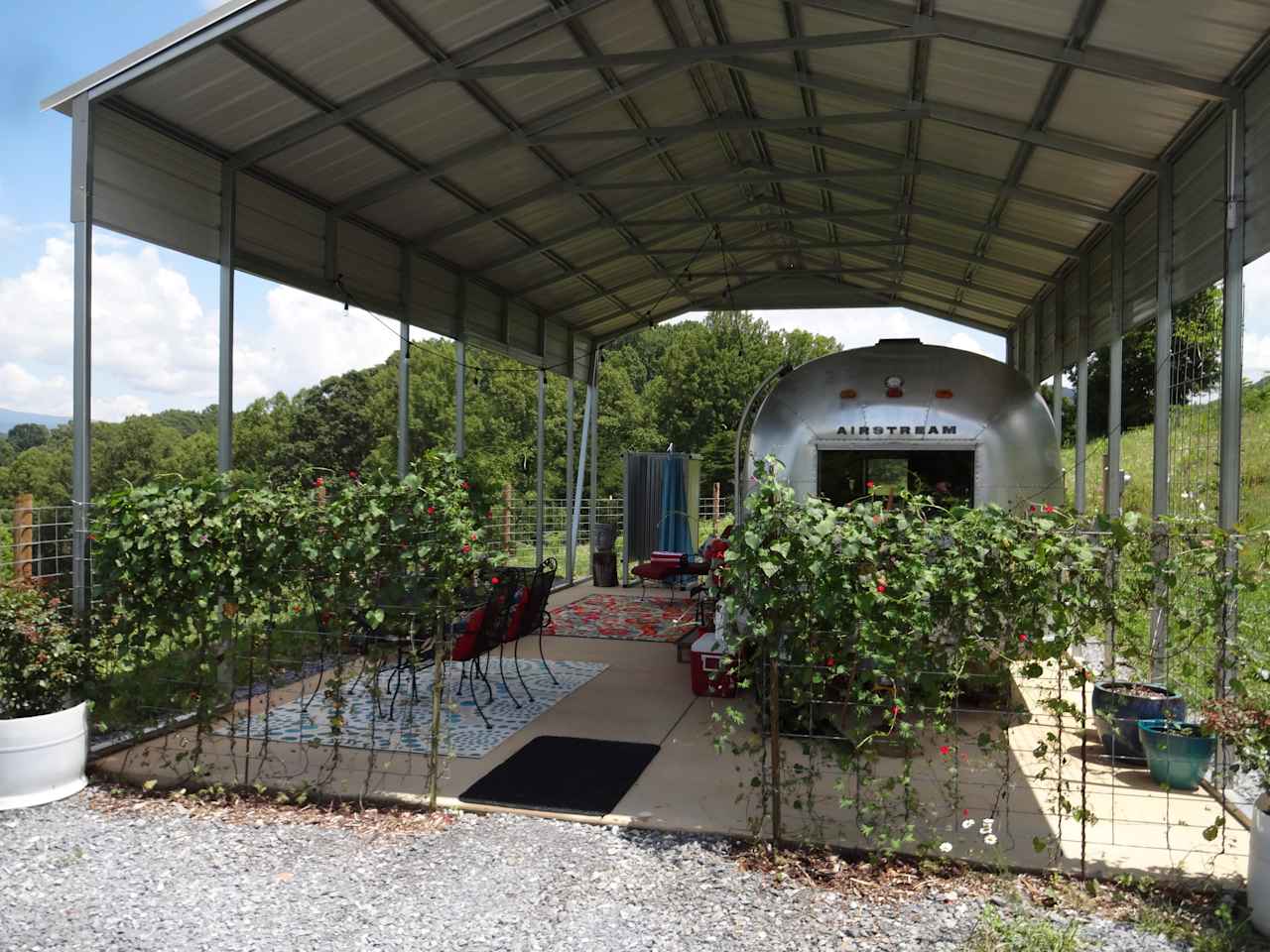 Entry framed by flowering vines.  Your own driveway leads to this spot with plenty of parking for two vehicles.