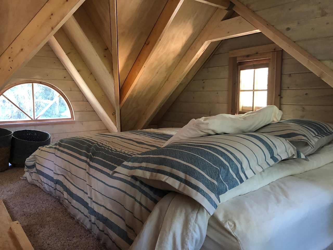 Comfy upstairs sleeping loft with four windows.