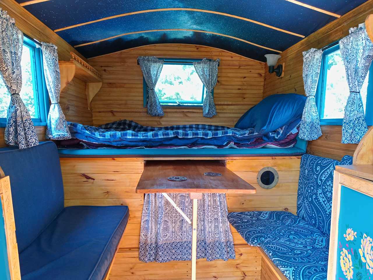 A cozy bed for one or two under a starry ceiling
