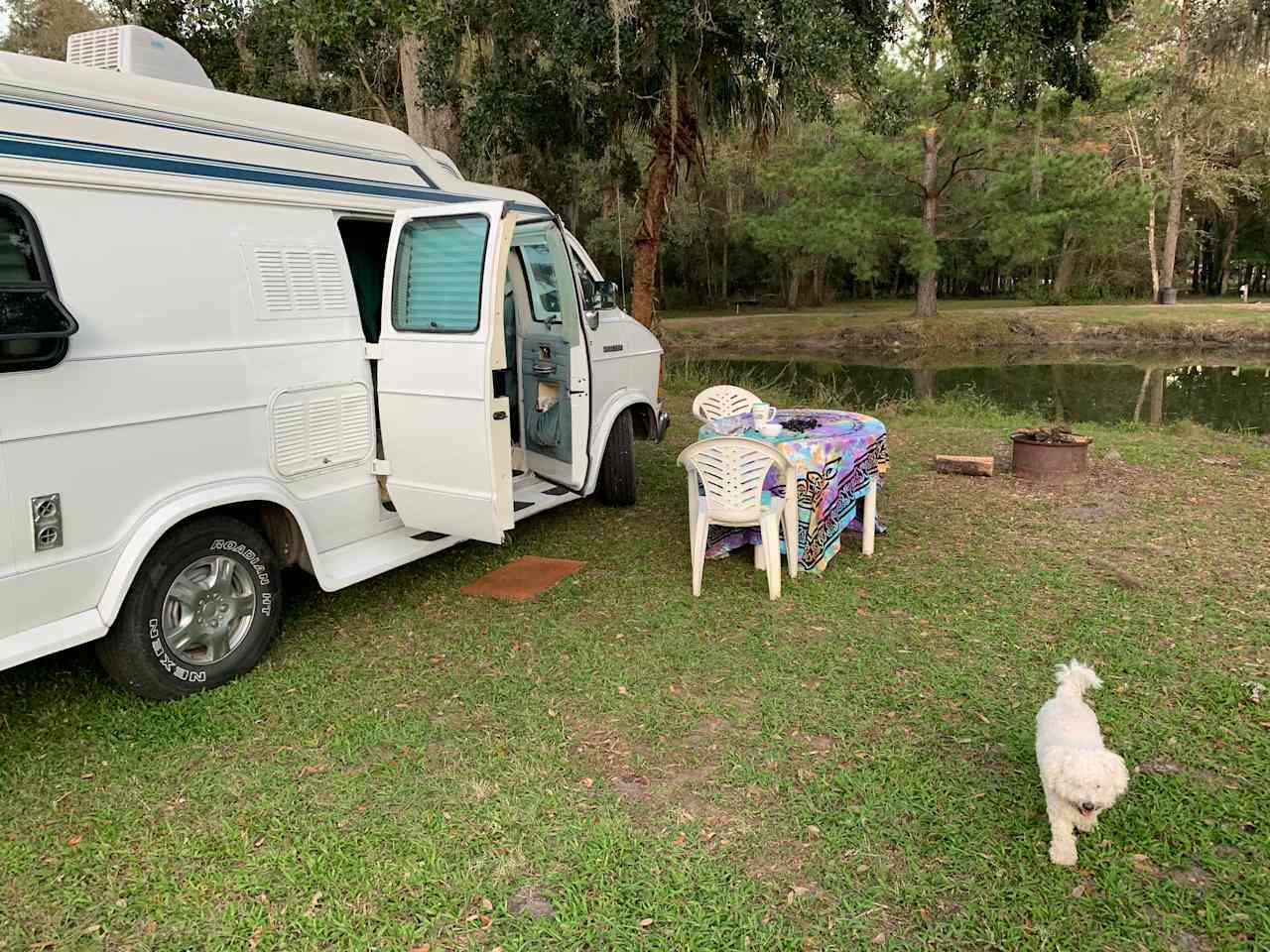Parked in front of the pond, under the oak trees. 