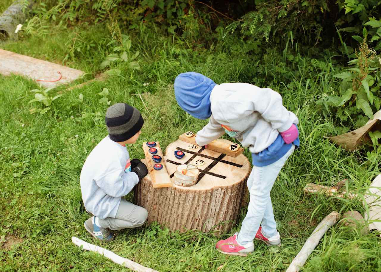 A wood and stone tic tac toe set is available for use.
