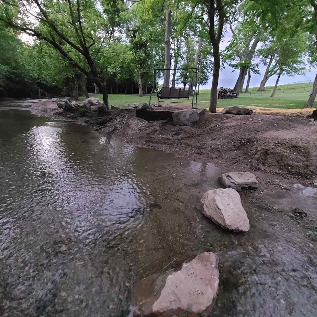 Relax on the new swing perch by the creek under the trees!