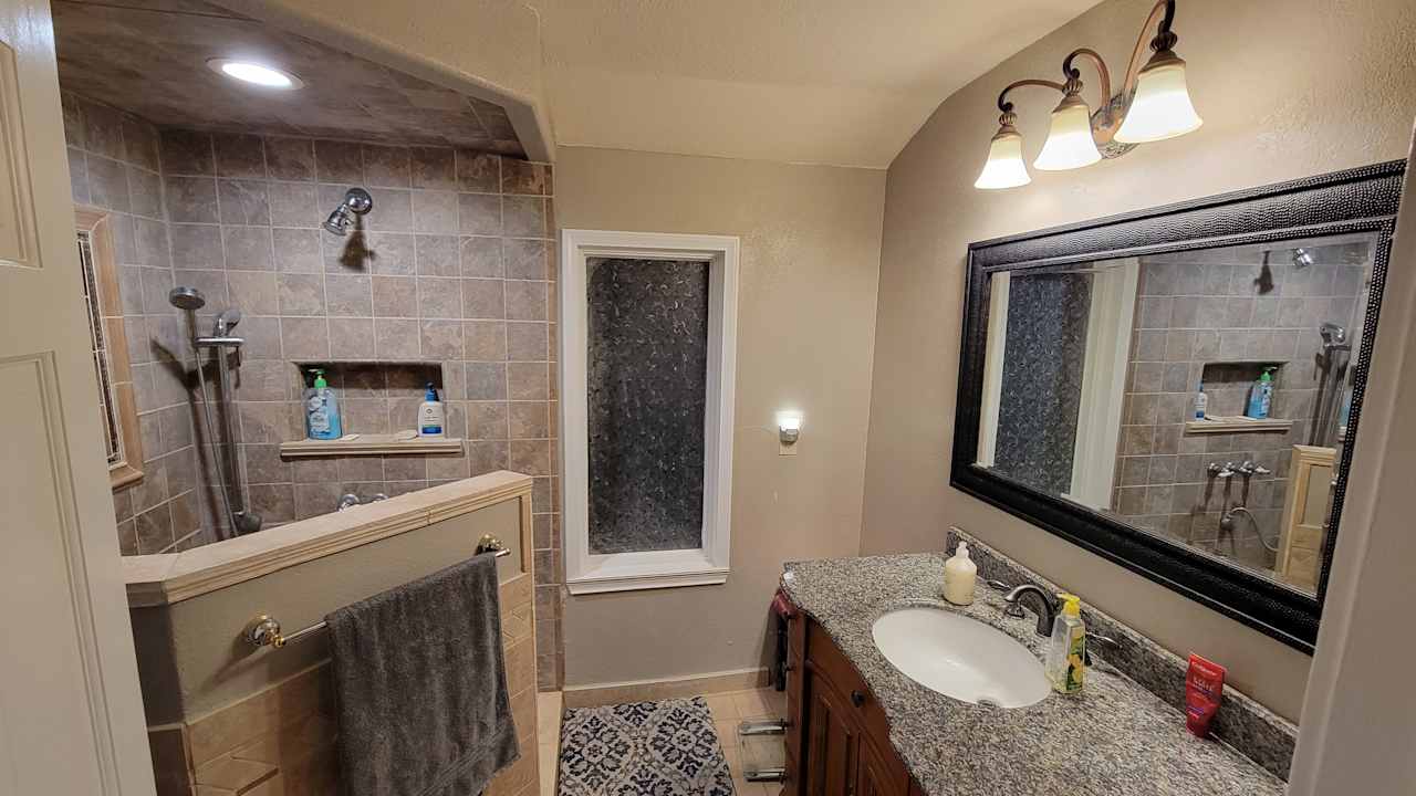 Full bath with walk-in shower, with the toilet behind the door, and tankless water heater for nearly unlimited hot water.