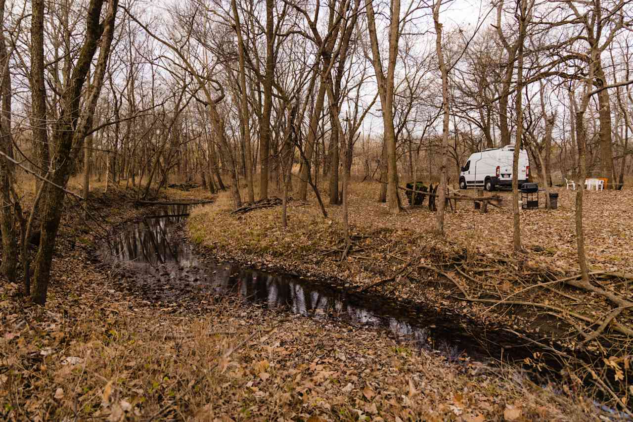 A view of our campsite from a creek, there is also a beautiful river on property that is great to play in during the summer!