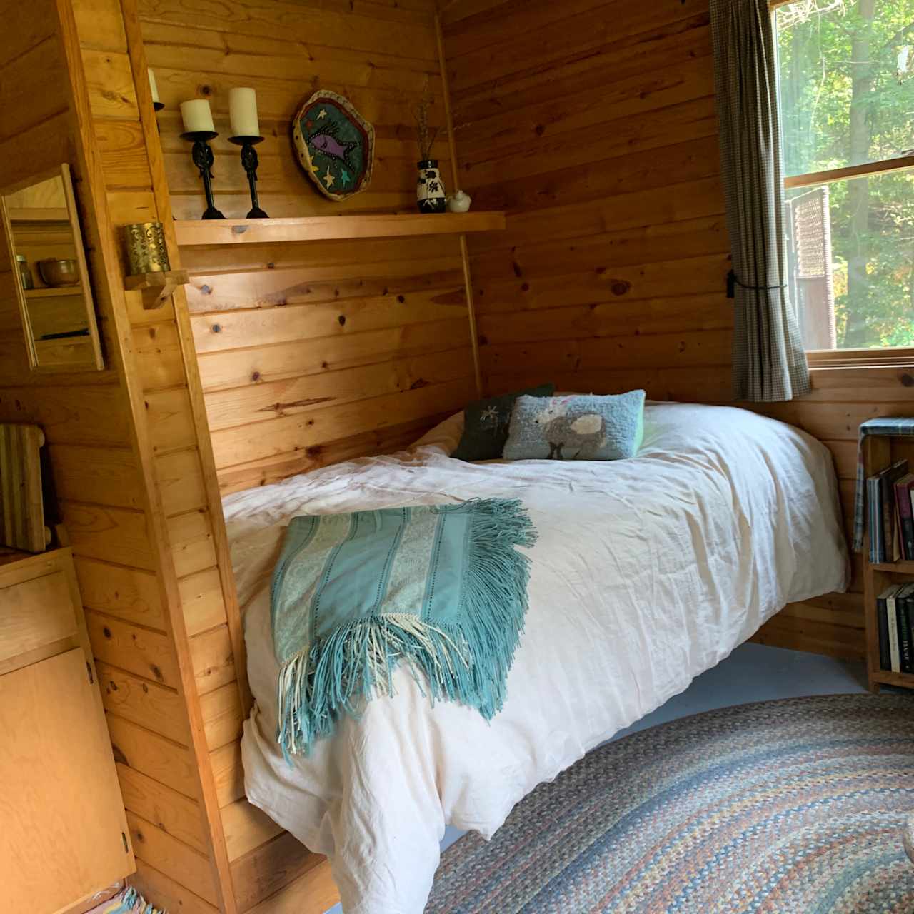 Full size bed with featherbed and down comforter.
