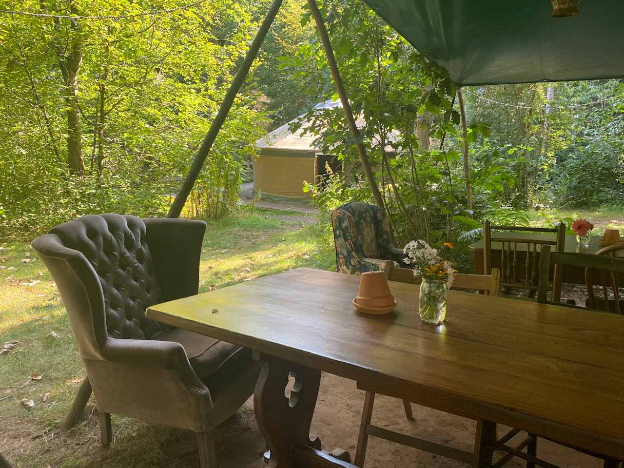 Foxglove yurt in the background. Use the under canvas for eating together or kids activities. 